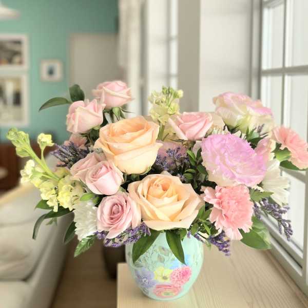 Pastel rose bouquet in a painted ceramic vase