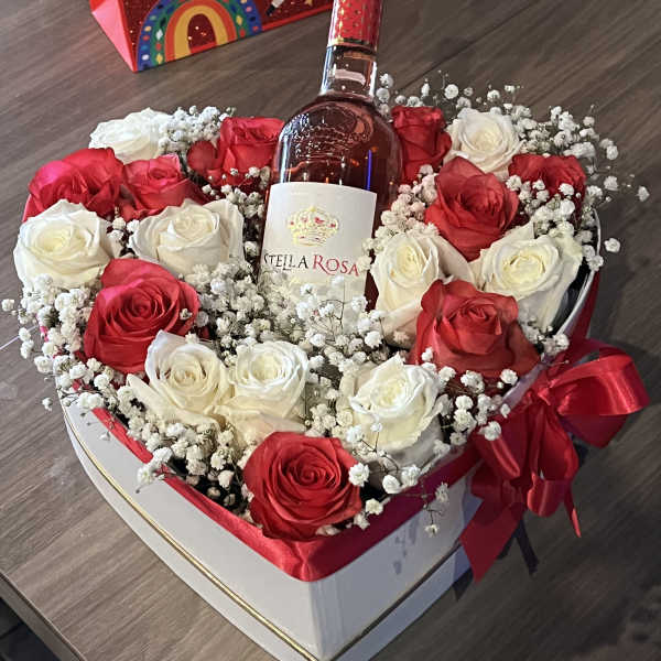 Heart-shaped rose box with a wine bottle and red ribbon