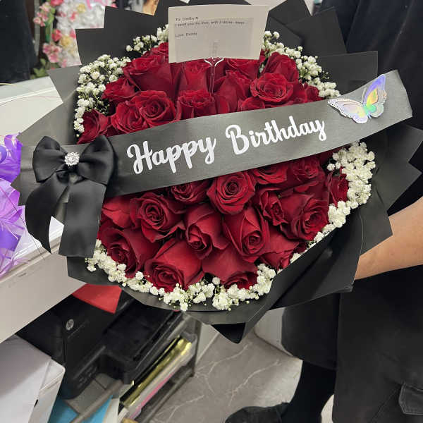Bouquet of red roses with baby's breath and a Happy Birthday ribbon