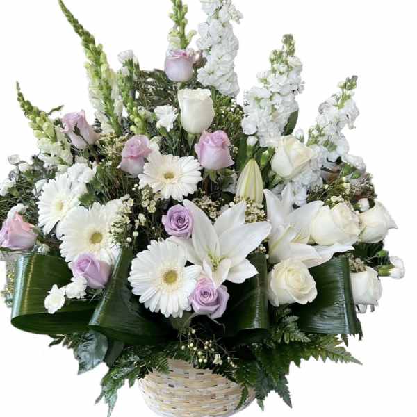 Basket arrangement of white lilies, roses, and daisies with pale lavender roses