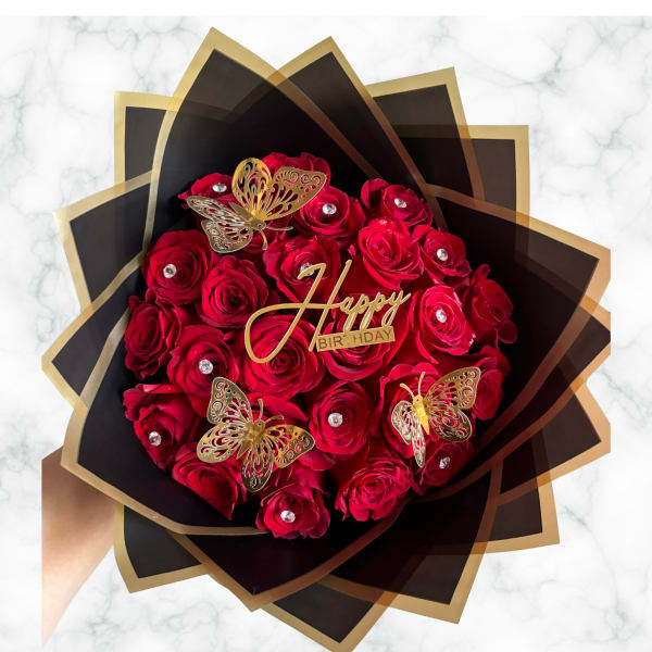 Red rose bouquet with gold butterfly accents and a Happy Birthday topper