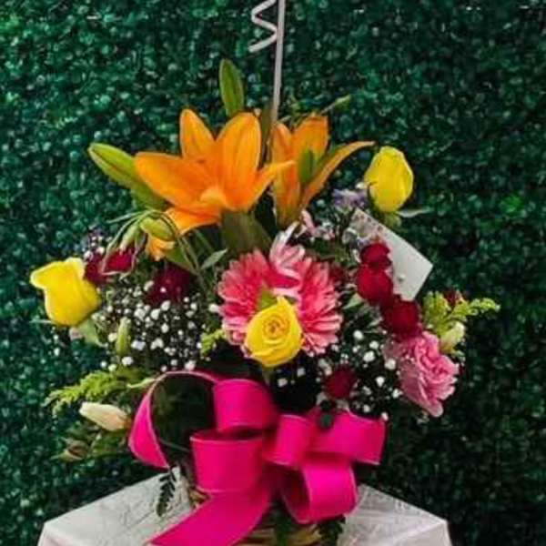 Mother's Day balloon above a colorful flower basket with a pink bow