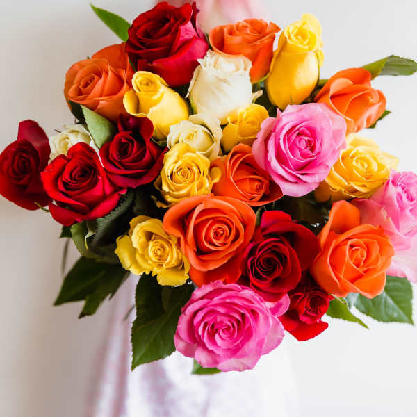 Bouquet of multicolored roses with a pink ribbon