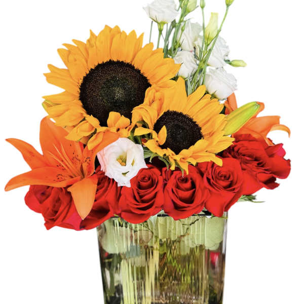 Bouquet of red roses, sunflowers, orange lilies, and white lisianthus in a glass vase