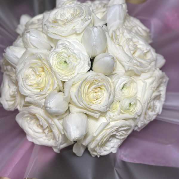 White rose and tulip bouquet wrapped in lavender paper