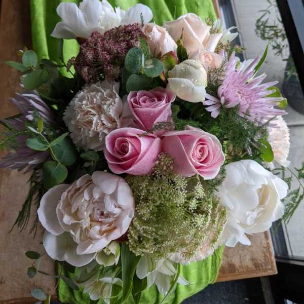 Bouquet of pink and white roses with mixed blooms and greenery