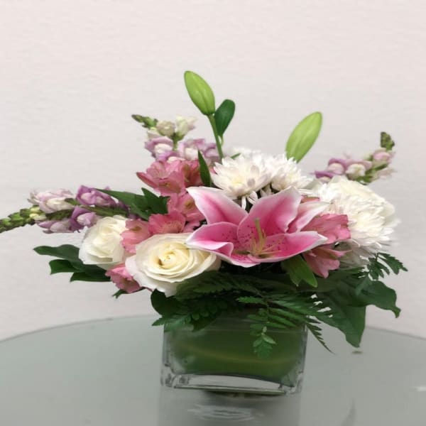 Pink lilies and white roses in a glass vase