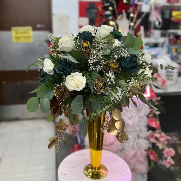 White and dark roses in a gold vase with eucalyptus and baby's breath