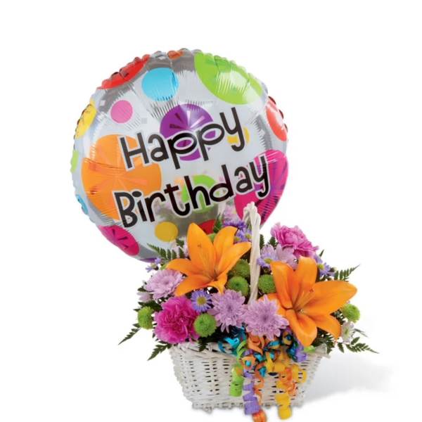 Birthday balloon with bright orange lilies and mixed flowers in a white basket