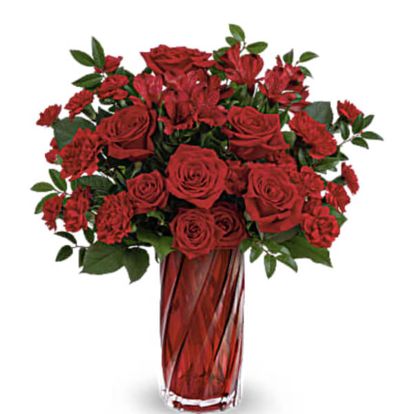 Red roses and carnations in a red glass vase