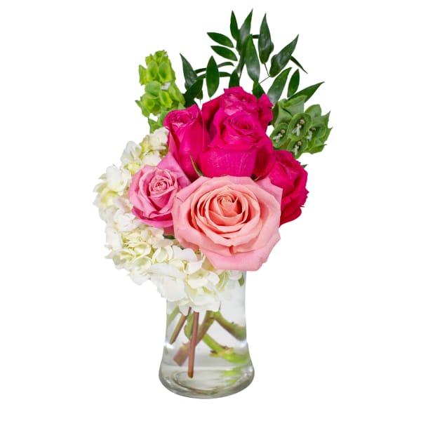 Pink and white roses in a clear glass vase