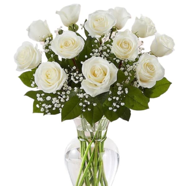 White roses arranged in a clear glass vase