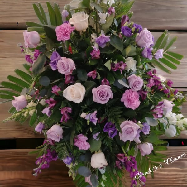 Large bouquet of pink, lavender, and white roses with purple flowers