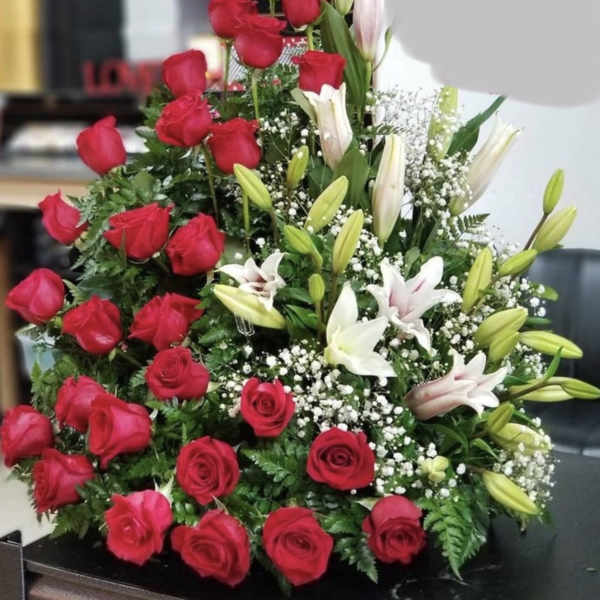 Large arrangement of red roses and white lilies