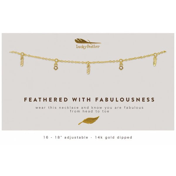 Gold chain necklace with small feather and crystal charms displayed on a white card with printed text.