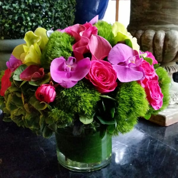 Bright pink and purple bouquet in a glass vase