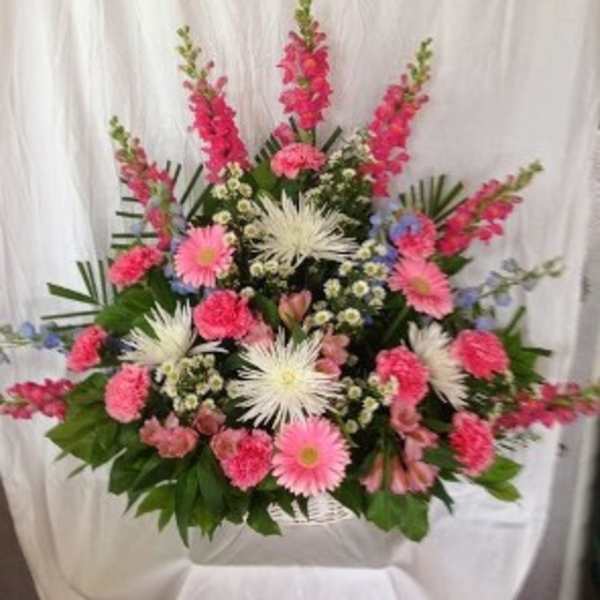 Large pink and white floral arrangement with gerbera daisies and carnations