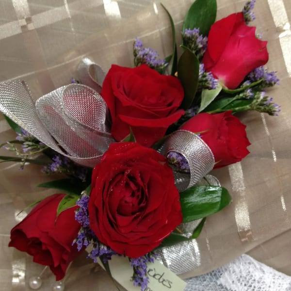 Bouquet of red roses with purple filler and silver ribbon wrap