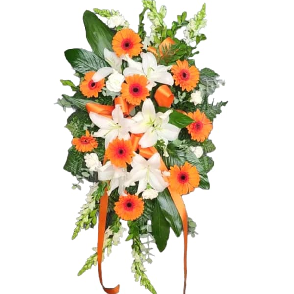 Orange gerberas and white lilies in a cascading floral spray