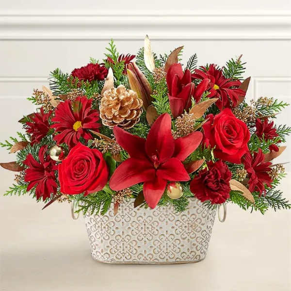 Red floral arrangement in a patterned white container