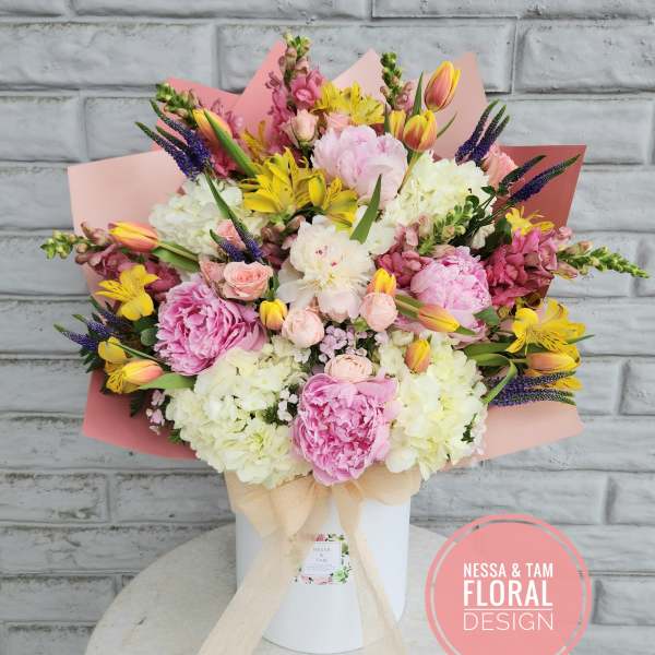 Large pastel bouquet in a white box with pink wrapping
