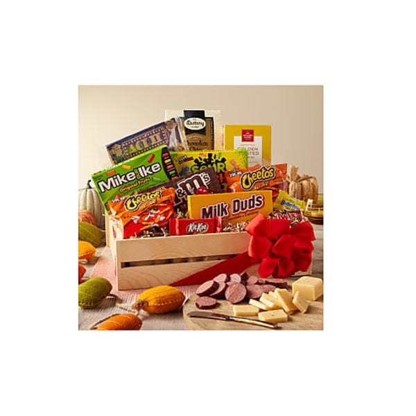 Gift crate filled with assorted candy and snack bars with a red ribbon bow