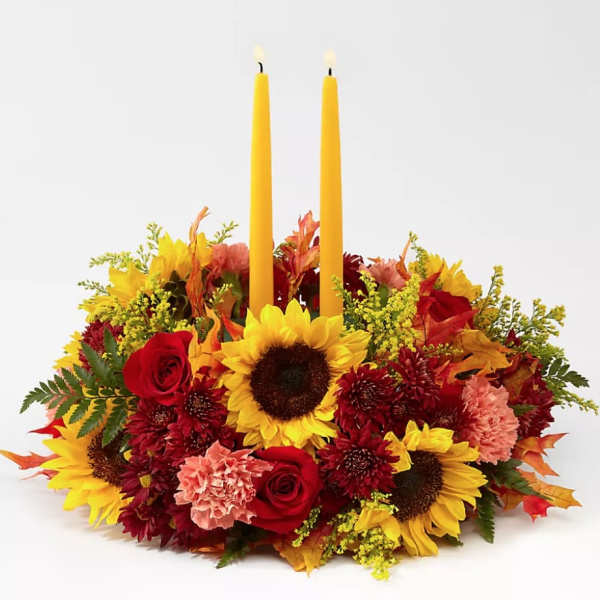 Autumn floral centerpiece with two yellow candles