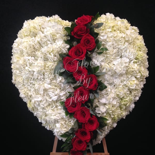 Heart-shaped white floral spray with a red rose cascade on an easel