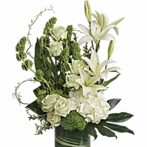 White lilies and roses in a green glass vase