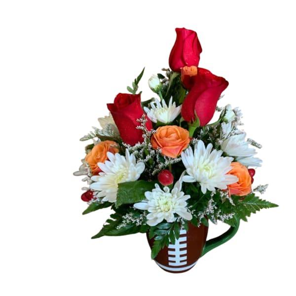 Red roses and white daisies in a football-shaped mug
