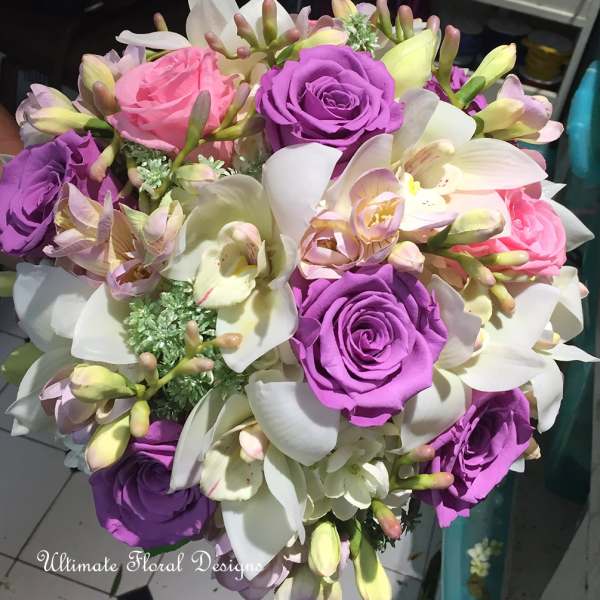 Bouquet of purple and pink roses with white orchids