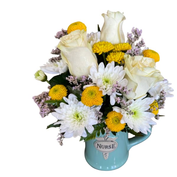 White roses and yellow daisies in a blue nurse mug