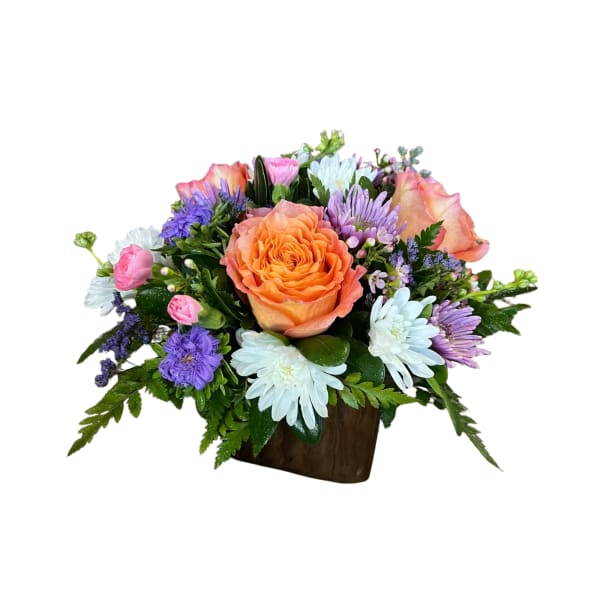 Mixed bouquet with an orange rose and purple and white flowers in a brown container