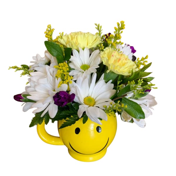 Daisy bouquet in a yellow smiley-face mug