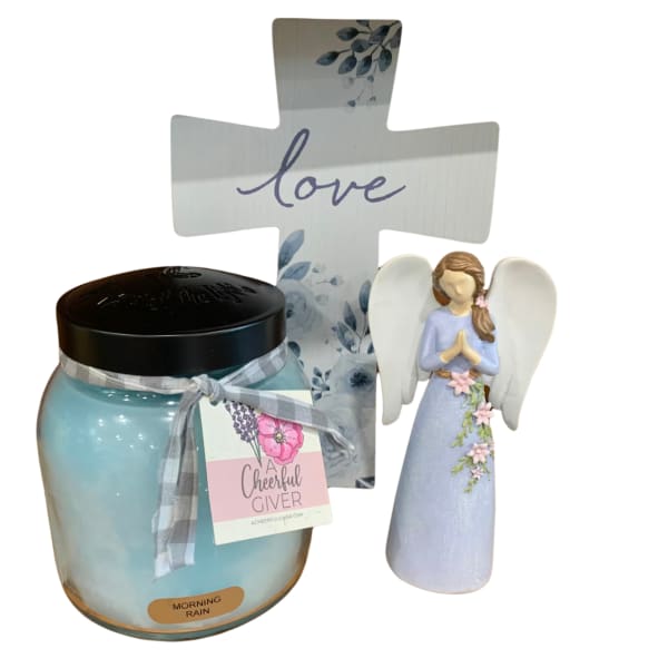 Gift set with a blue candle, angel figurine, and decorative cross sign