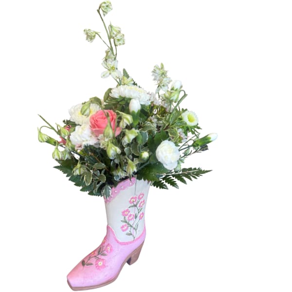 Bouquet of pink and white flowers arranged in a painted boot vase