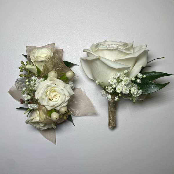 Two white rose boutonnieres with gold ribbon and baby's breath