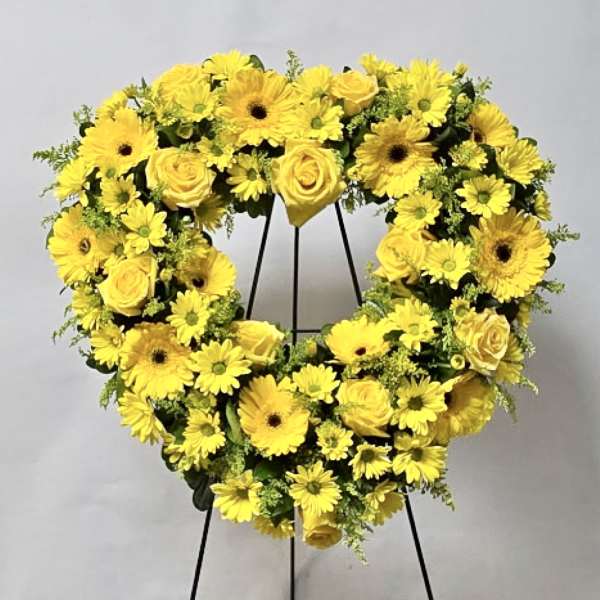Yellow flower wreath on a black stand