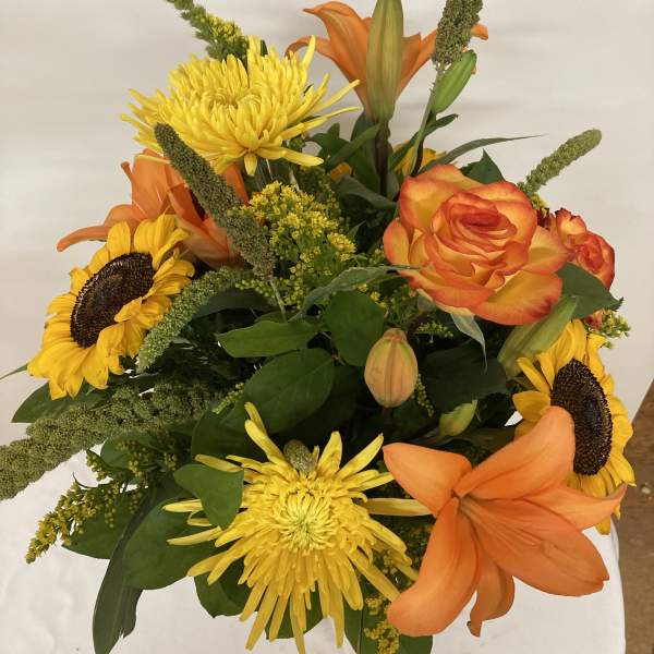 Bouquet of orange lilies, yellow chrysanthemums, and sunflowers