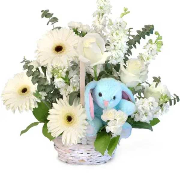 White flowers in a basket with a blue plush bunny