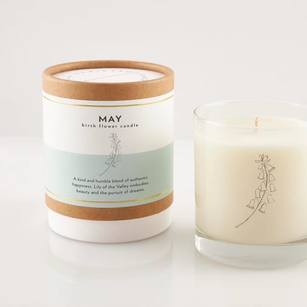 Two lily of the valley candles, one in a box and one in a glass jar