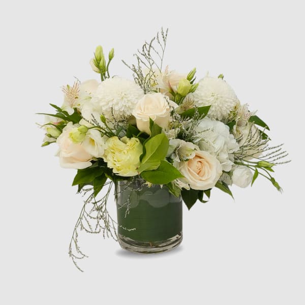 White and blush bouquet in a glass vase