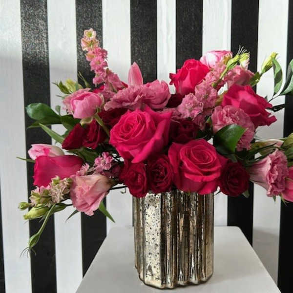 Pink and red rose bouquet in a metallic vase
