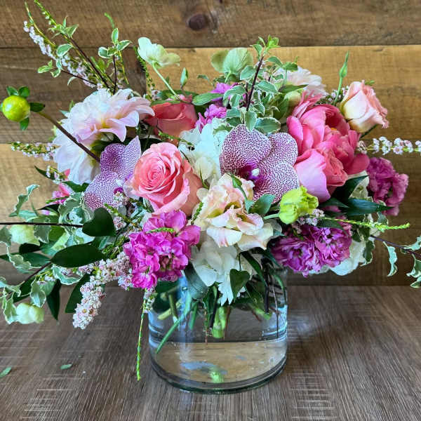 Pink and white mixed flower arrangement in a clear glass vase