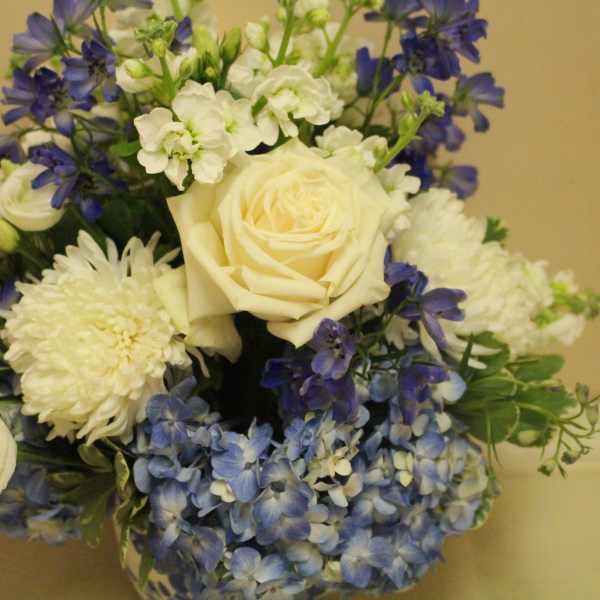 Bouquet of white roses, blue flowers, and white mums