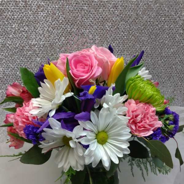 Bouquet of pink roses, white daisies, and colorful mixed flowers