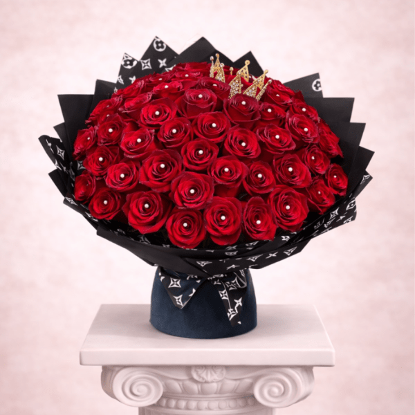 Large bouquet of red roses in black wrapping with gold crown accents
