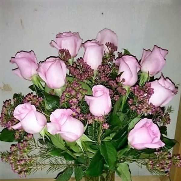 Pink roses arranged in a clear glass vase