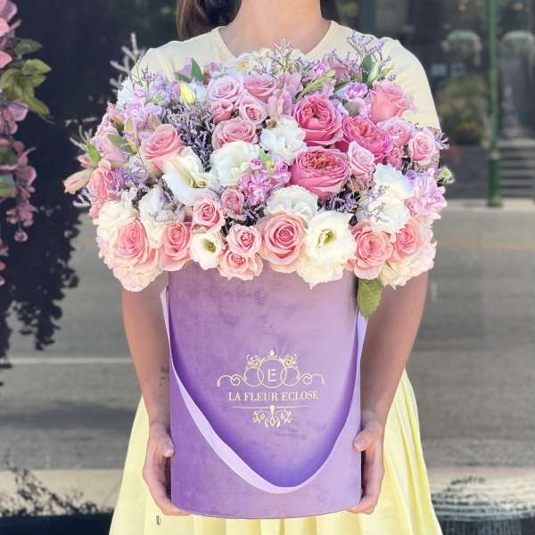 Large pink and white rose bouquet in a purple gift box