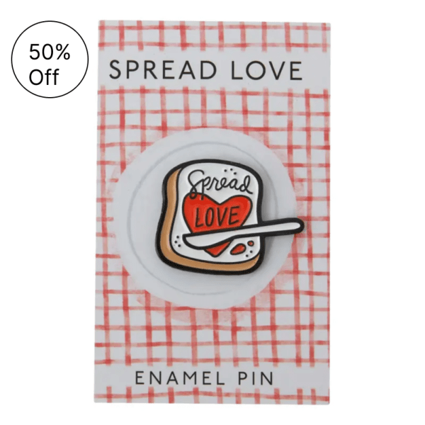 Enamel pin on a card that says Spread Love.